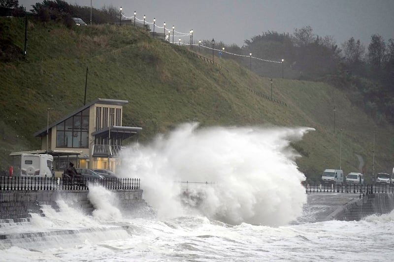 Waves crash over the promenade in Scarborough in North Yorkshire, England. AP