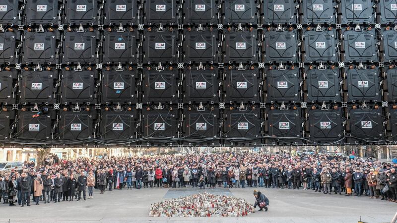 People gather to watch a broadcast of the funeral service for Gdansk Mayor Pawel Adamowicz, in Poznan, Poland. Reuters