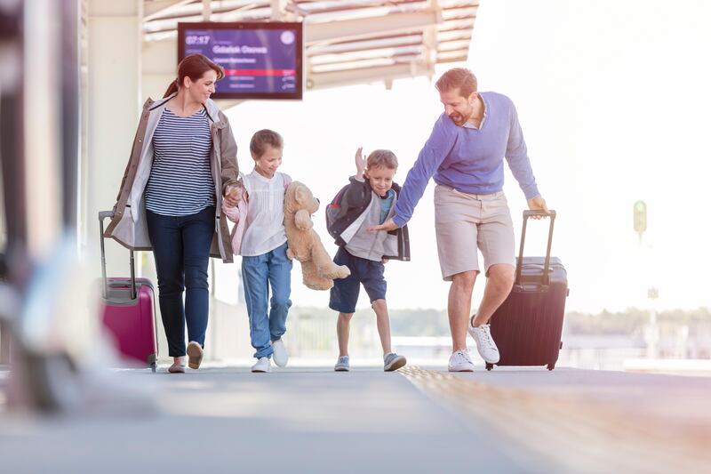 Family walking pulling suitcases at train station (Getty Images) *** Local Caption ***  wk30de-tr-tips09.jpg