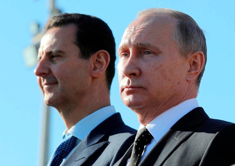 FILE - This Monday, Dec. 11, 2017 file photo, Russian President Vladimir Putin, right, and Syrian President Bashar Assad watch the troops marching at the Hemeimeem air base in Syria. Nearly seven years into the conflict, the war in Syria seems on one level to be winding down, largely because of Russian-backed government victories and local cease-fires aimed at freezing the lines of conflict. (Mikhail Klimentyev, Sputnik, Kremlin Pool Photo via AP, File)