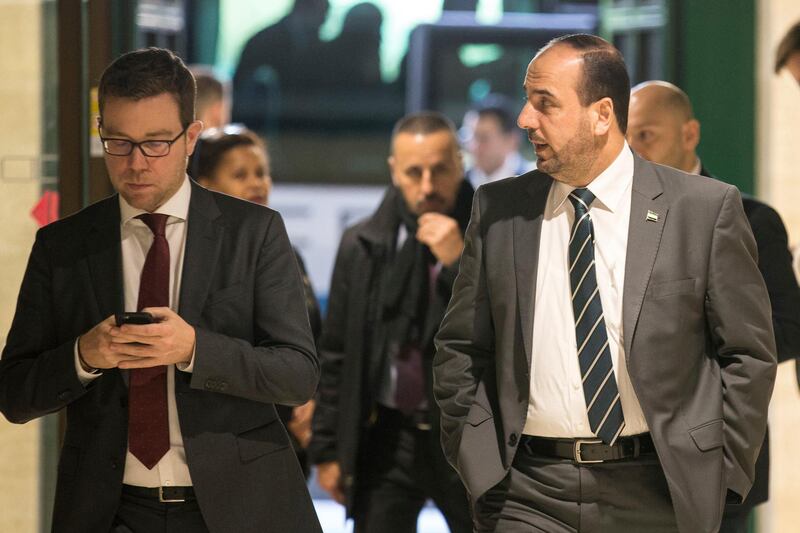 Nasr al-Hariri, right, head of the Syrian Negotiation Commission (SNC), arrives for a meeting with UN Special Envoy for Syria Staffan de Mistura at the Intra Syria talks, at the European headquarters of the United Nations in Geneva, Switzerland, Tuesday, Dec. 12, 2017. (Xu Jinquan/pool photo via AP)