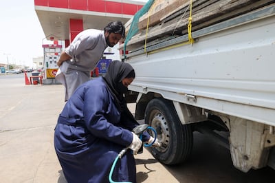 At the Petromin Express garage in Jeddah, on the Red Sea coast, new female recruits check oil and change tyres alongside their male counterparts as part of a nationwide push to bring more women into the workforce. AFP