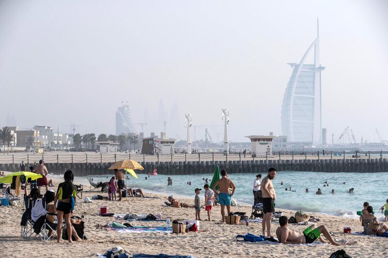 DUBAI, UNITED ARAB EMIRATES. 06 JUNE 2020. Busy Dubai beaches after the beach restrictions were lifted in Dubai. Residents and visitors visit the beach near Kite Beach in Dubai even though the timperatures are in the high 30’s with high humidity. With social distancing in place the wearing of masks compulsary. (Photo: Antonie Robertson/The National) Journalist: None. Section: National.