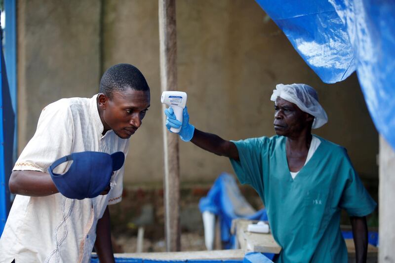 A health worker measures the temperature of a man entering an Ebola treatment centre in Beni, Congo in April. Reuters