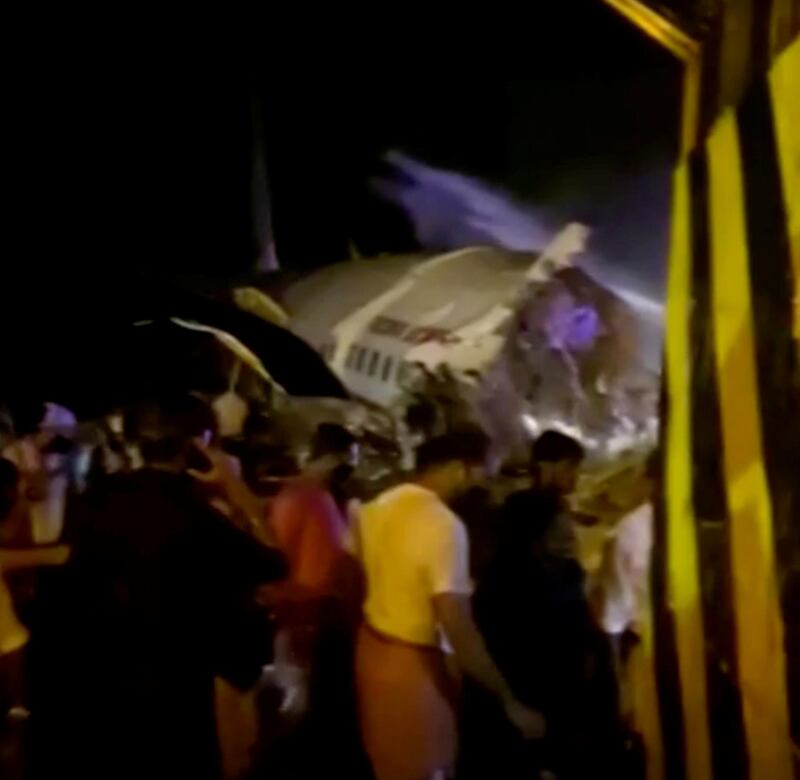 Images from India's ANI news agency show a damaged Air India Express plane that crashed close to the runway at Kozhikode International Airport. ANI / Reuters
