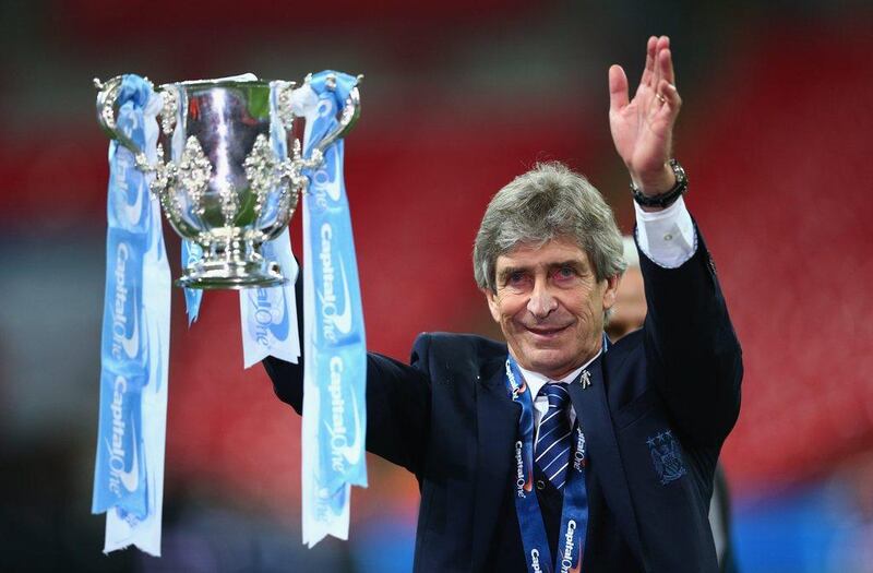 Manuel Pellegrini manager of Manchester City celebrates victory with the trophy after the Capital One Cup Final match between Liverpool and Manchester City at Wembley Stadium on February 28, 2016 in London, England. Manchester City won 3-1 on penalties. (Photo by Clive Brunskill/Getty Images)