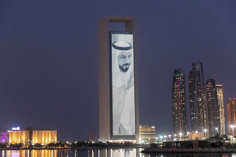 ABU DHABI, UNITED ARAB EMIRATES. 19 JULY 2018. A LED screen plays portraits of the UAE Leadership along with a message in Mandari honouring the Chinese Prime Ministers state visit to the UAE on the ADNOC HQ building on the Corniche. (Photo: Antonie Robertson/The National) Journalist: None. Section: National.