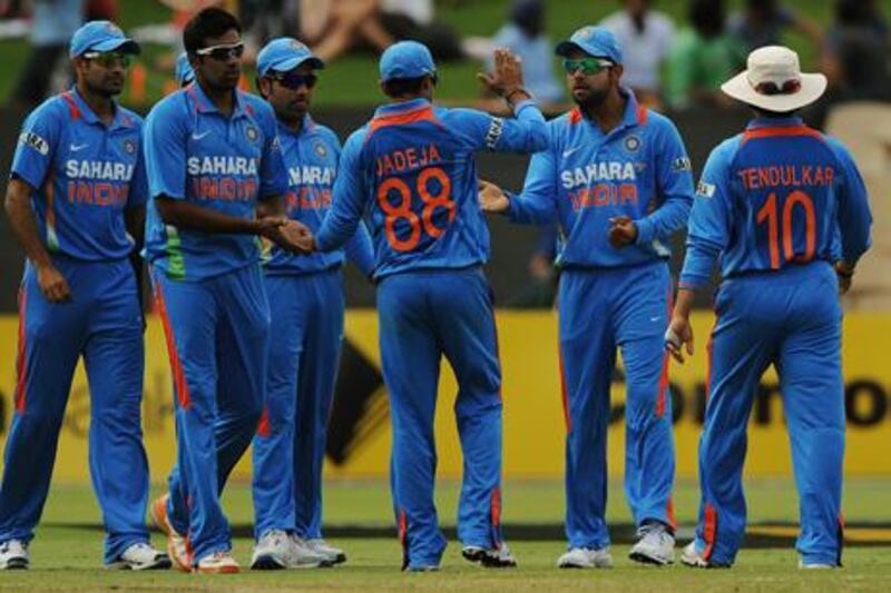 India celebrate the dismissal of Sri Lankan batsman Thisara Perera from a catch by Virat Kohli (2nd-R) during the one day international cricket match in Adelaide on February 14, 2012. IMAGE STRICTLY RESTRICTED TO EDITORIAL USE - STRICTLY NO COMMERCIAL USE  AFP PHOTO / Greg WOOD

