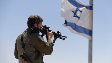 A soldier looks at the border with the Gaza Strip at a view point in Sderot, Israel. Getty Images