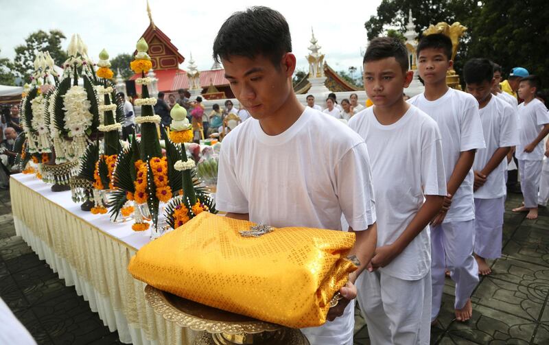 Chantawong, left front, and members of the team attend a Buddhist ceremony. AP Photo