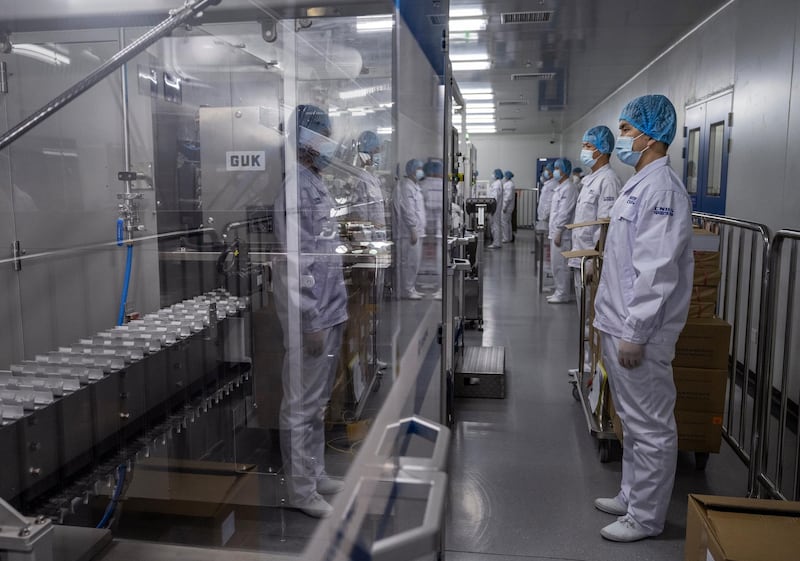 Workers in the packaging area of Sinopharm's vaccine production centre. Getty