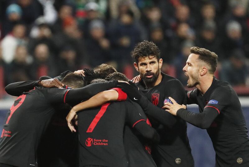 epa07887418 Diego Costa (2R), Saul Niguez (R) and their teammates of Atletico Madrid celebrate after scoring their second goal during the UEFA Champions League match between Lokomotiv Moscow and Atletico Madrid in Moscow, Russia, 01 October 2019.  EPA/MAXIM SHIPENKOV