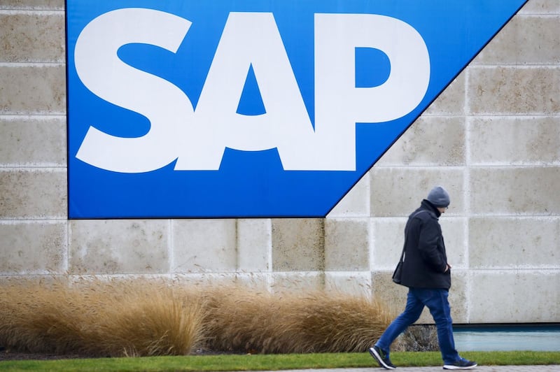 A visitor passes the SAP SE logo at the company's headquarter campus site in Walldorf, Germany, on Tuesday, Jan. 28, 2020. SAP, Europe’s biggest software company, boosted its revenue and operating profit forecasts for 2020 after reporting fourth quarter income that met analyst estimates. Photographer: Alex Kraus/Bloomberg