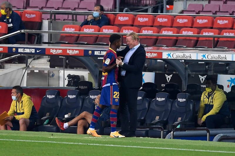 Coach Ronald Koeman greets Barcelona's Spanish forward Ansu Fati. AFP