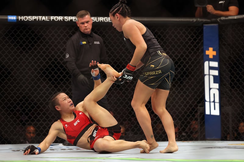 Weili Zhang battles Carla Esparza during their Women Strawweight fight at UFC 281. Getty
