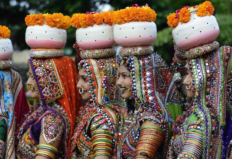 Folk dancers from the Panghat Group of Performing Arts pose for a photograph during a dress rehearsal for an event to mark the forthcoming Hindu festival 'Navaratri', or the Festival of Nine Nights, in Ahmedabad.  Sam Panthaky / AFP