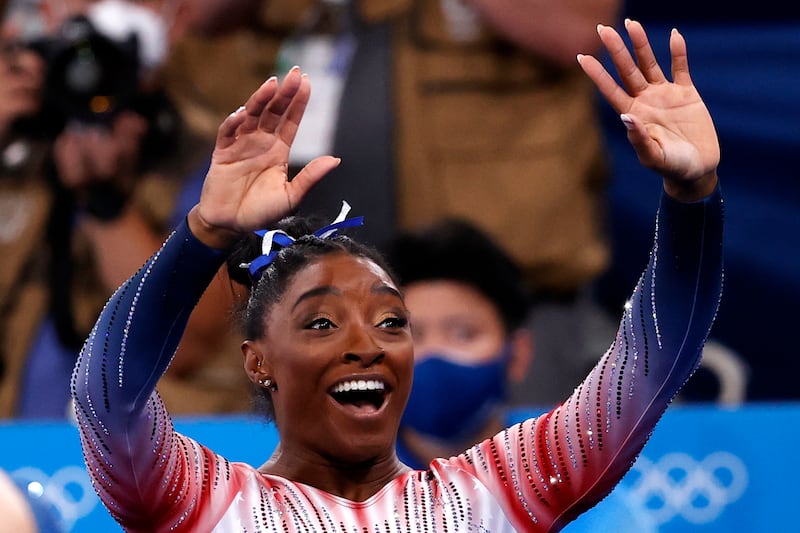 Simone Biles of the USA waves to the crowd.