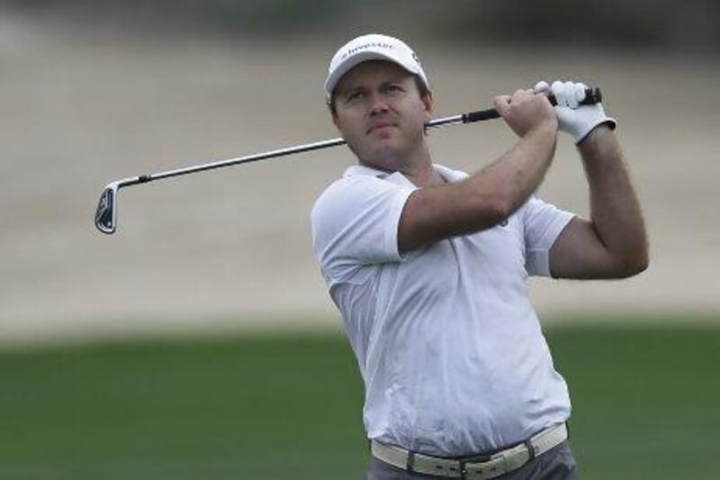 Richard Sterne from South Africa plays a ball on the 12th hole during the second round of the Dubai Desert Classic on Friday. Sterne holds a slim one-shot lead on the field. Kamran Jebreili / AP Photo