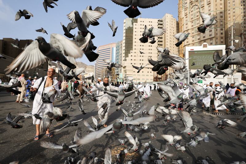Doves and pilgrims outside the Grand Mosque in Makkah. Reuters