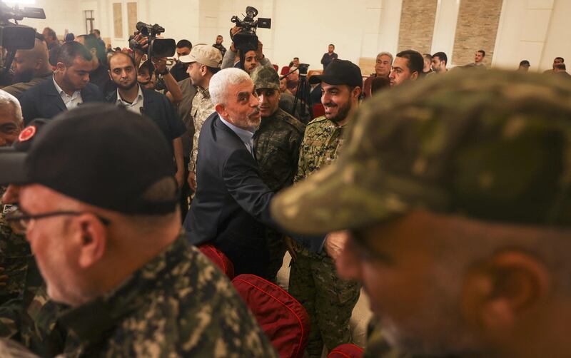 Yahya Sinwar greets members of the the Ezzedine Al Qassam Brigades, the armed wing of Hamas. AFP