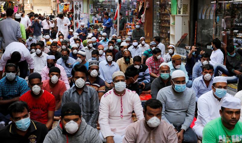 Muslims wear protective face masks following the coronavirus outbreak, as they pray on a street during Friday prayers in local souq, in Manama, Bahrain. Reuters