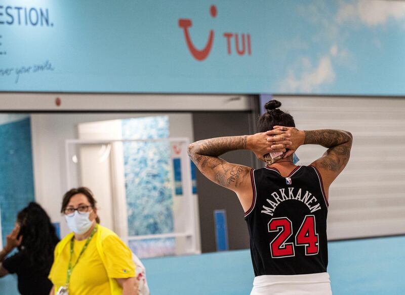 A traveler reacts next to a TUI travel company stand at Palma de Mallorca's Airport in Palma, Balearic Islands, Spain. TUI canceled all its flights to Spain, including Balearic Islands and excepting Canary Islands, after a recommendation from the German government. EPA