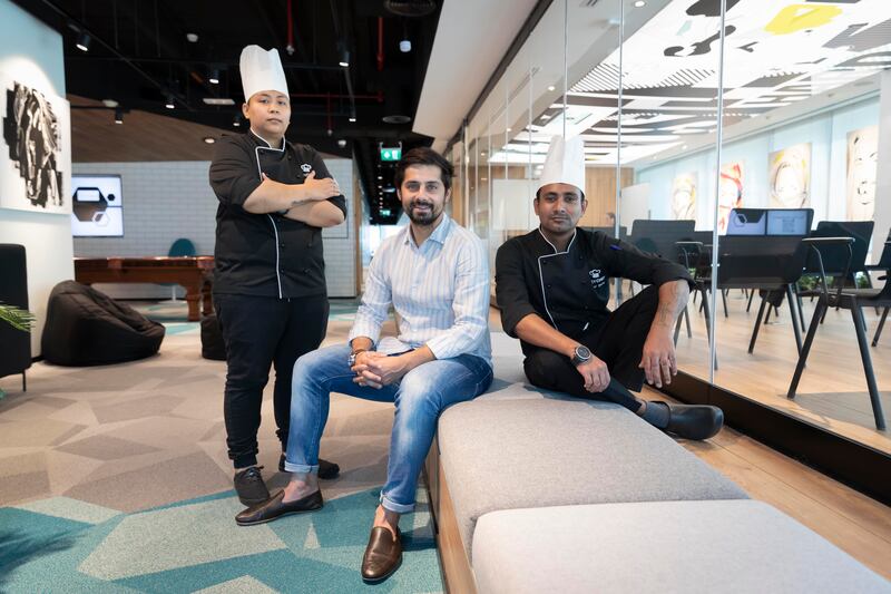 Pranav Arora with chefs Casey Catingan, left, and Anand Bhutia, right. HeyChef was launched in May last year with only two chefs, but now has six. Photo: Antonie Robertson / The National