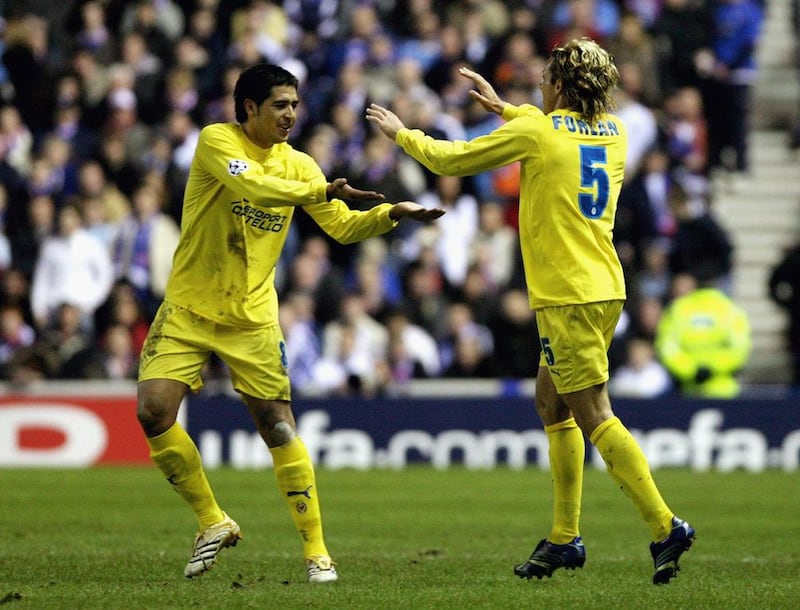 Diego Forlan and Juan Roman Riquelme celebrate after scoring during the UEFA Champions League match between Villarreal and Rangers. Jeff J Mitchell / Getty
