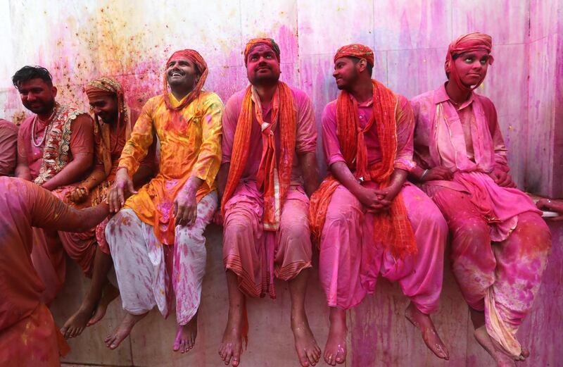 Hindu men from the villages of Nandgaon and Barsana covered with coloured powder celebrate the Lathmar Holi festival at the Nandgram temple in Nandgaon, Mathura, India, 05 March 2020. EPA