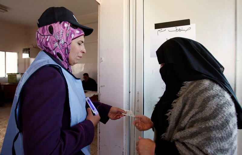 A Jordanian woman has her identity documents checked by an observer as she arrives at a polling station ahead of casting a ballot in the parliamentary elections, Al-Salt, Jordan, Wednesday, Jan. 23, 2013. Jordanians voted Wednesday for a parliament touted to be the most powerful in the kingdom's history, but with much of the opposition boycotting it is unclear how far the vote and its accompanying reforms will go to pacify a two-year long wave of protests. (AP Photo/Mohammad Hannon) *** Local Caption ***  Mideast Jordan Elections.JPEG-06792.jpg