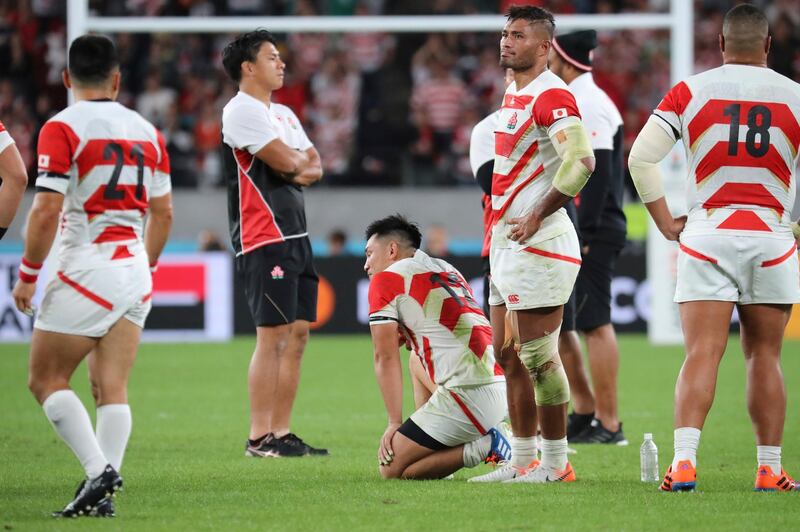 Japan players react after their 26-3 loss to South Africa in the Rugby World Cup quarterfinal match at Tokyo Stadium in Tokyo, Japan, Sunday, Oct. 20, 2019. (AP Photo/Eugene Hoshiko)