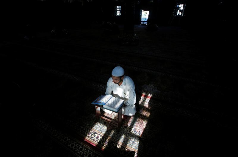 A Kashmiri man reads the Quran in Srinagar.  Reuters