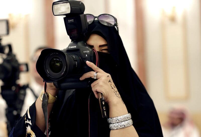 In this Tuesday, Nov. 10, 2015 photo, a journalist takes photos at a palace in Riyadh, Saudi Arabia. Outside the Saudi capital of Riyadh, in one of the country’s most conservative provinces, Jowhara Al-Wably is making history by running as a female candidate in upcoming elections. Saturday’s vote for municipal council seats marks two milestones for Saudi women: It is the first time women are allowed to vote in a government election and the first time women can run as candidates. (AP Photo/Hasan Jamali)