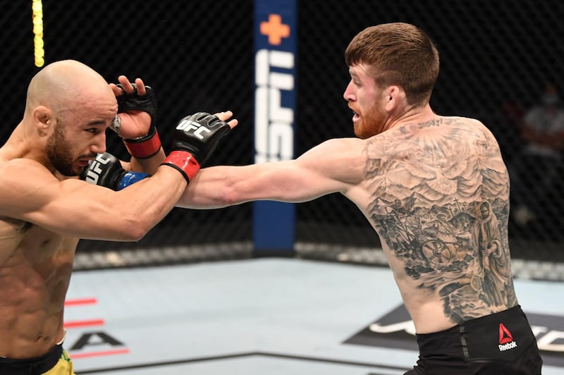 Cory Sandhagen (R) punches Marlon Moraes of Brazil in their bantamweight bout during the UFC Fight Night event inside Flash Forum on UFC Fight Island in Abu Dhabi, United Arab Emirates. Josh Hedges/Zuffa LLC via Getty Images