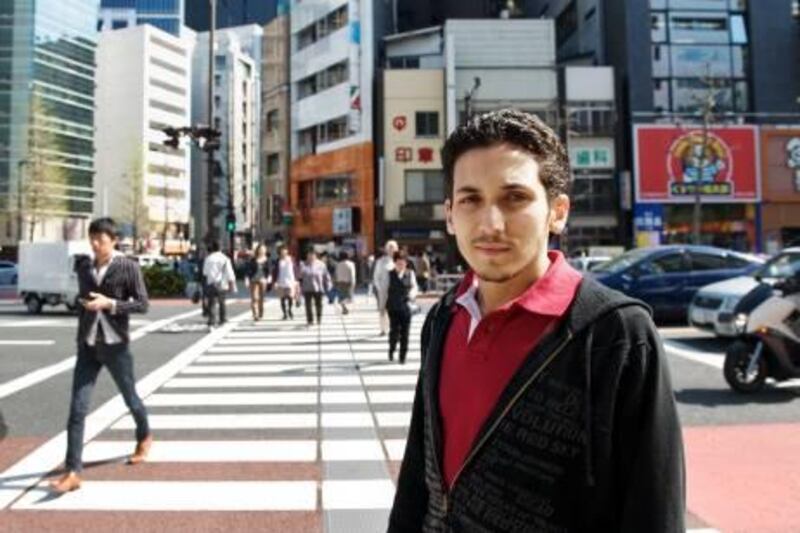 Tokyo -- April 14, 2011 -- Alharith al Hashmi, a 20-year-old Emirati student attending school in the Japanese capital, stands by an intersection in the central Ochanomizu area. Having been away when the March 11 earthquake struck, he recently returned to the shell-shocked nation to resume his studies. Although the quake's actual impact in Tokyo was minimal, some products have been in short supply, and an electricity shortage is a major concern as summer approaches. ((Kayo Yamawaki for The National) 