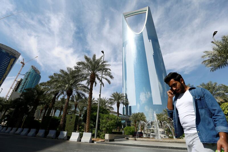 FILE PHOTO: A man speaks on the phone as he walks past the Kingdom Centre Tower in Riyadh, Saudi Arabia, November 5, 2017. REUTERS/Faisal Al Nasser - /File Photo
