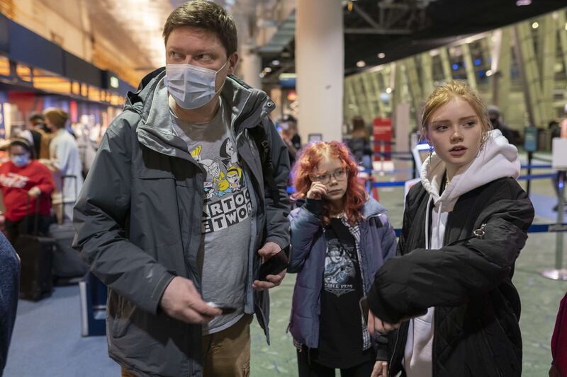 Sergey Korenev says goodbye to his two daughters in Portland, Oregon, before travelling to Ukraine to help in the war effort. He has gathered about $50,000 in donated medical aid which he plans to take to Ukraine before joining the fight.  Getty Images / AFP