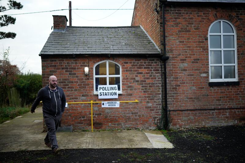 A member of the public leaves the Two Mills Presbyterian Church polling station after voting in the Chester by-election. Getty Images
