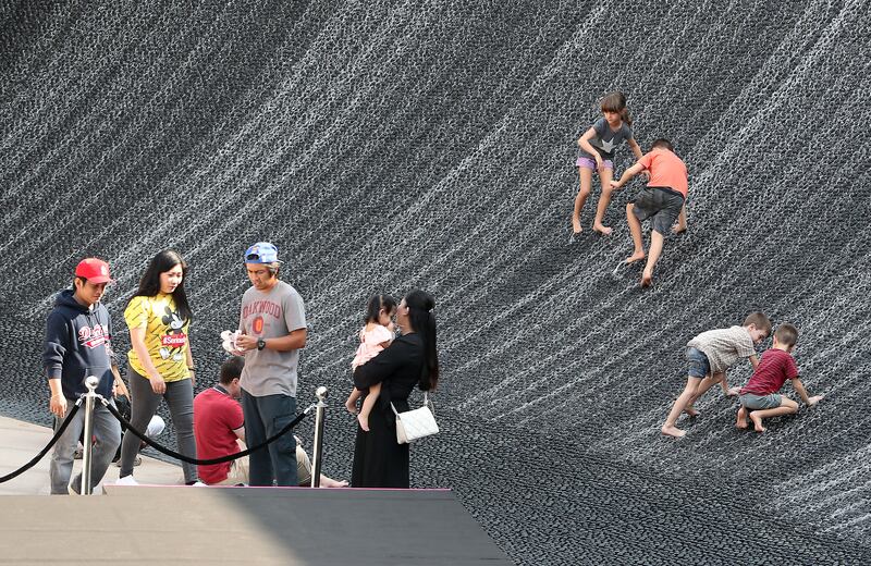 Visitors at the water feature in the Green Zone. Pawan Singh / The National