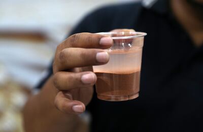 Dake demonstrates the water-retaining capacity of his breathable sand. Pawan Singh / The National