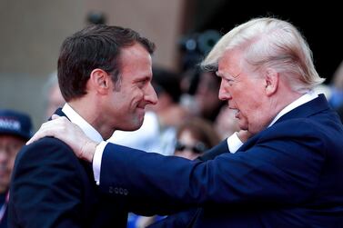 US President Donald Trump talks with French President Emmanuel Macron during a French-US ceremony in Normandy as part of D-Day commemorations marking the 75th anniversary of the World War II Allied landings.  AFP