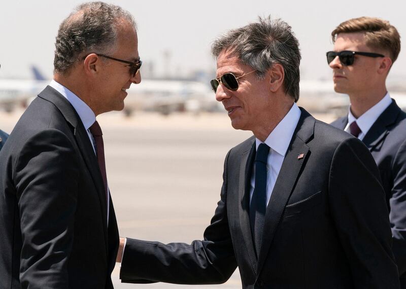 Mr Blinken is greeted by Jonathan Cohen, the US ambassador to Egypt,  as he arrives in Cairo. AFP