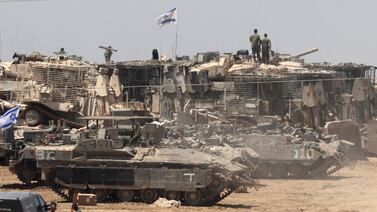 Israeli tanks line up near the border fence with the Gaza Strip, in southern Israel. EPA