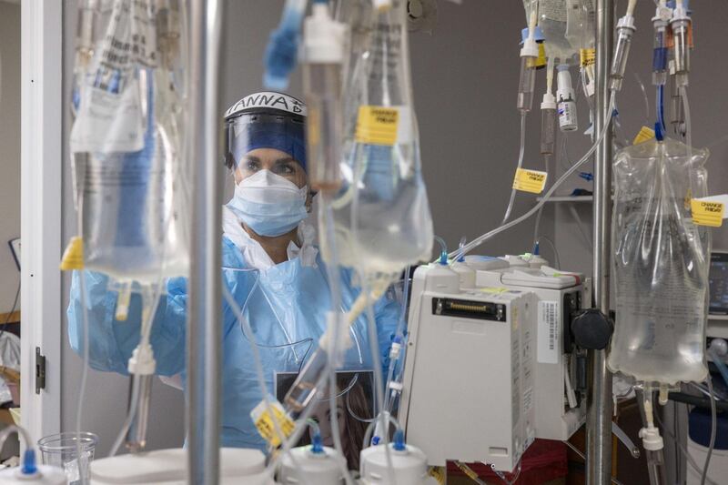 A medical staff member checks on a patient's intravenous drip device in the Covid-19 intensive care unit at the United Memorial Medical Center in Houston, Texas, USA. AFP