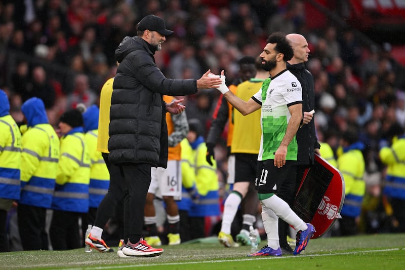 Jurgen Klopp shakes hands with Mohamed Salah as he leaves the field after being substituted. Getty Images
