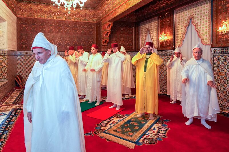 Moroccan King Mohammed VI Commander of the Faithful, third right, flanked at left by the Crown Prince Moulay El Hassan and his brother Prince Moulay Rachid, fourth left, pray during Eid Al Fitr at the residence of Sale near Rabat. AP