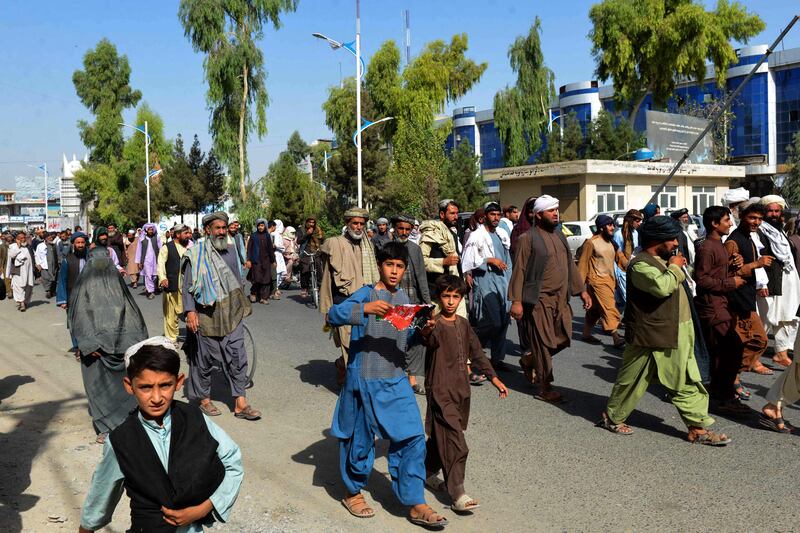 Local residents take part in a protest march against a reported announcement by the Taliban, asking them to evict their homes built on state-owned land in Kandahar. AFP