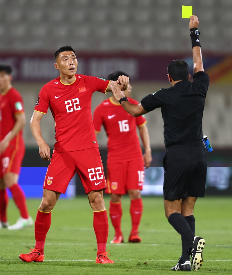Yu Dabao of China receives a yellow card. Getty