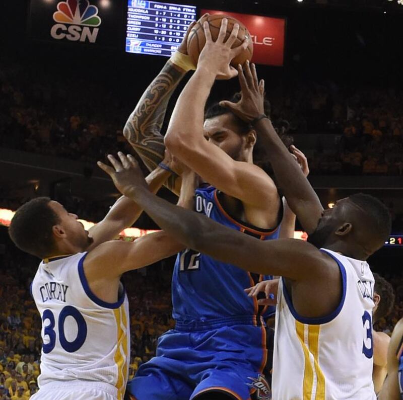 Oklahoma City Thunder center Steven Adams of New Zealand (C) gets pressured by Golden State Warriors guard Stephen Curry (L) and Golden State Warriors center Festus Ezeli of Nigeria (R) during their NBA Western Conference finals game seven at Oracle Arena in Oakland, California, USA, 30 May 2016. The Warriors defeated the Thunder 96-88 to advance to the NBA Finals to play the NBA Eastern Conference Champions Cleveland Cavaliers.  EPA/JOHN G. MABANGLO