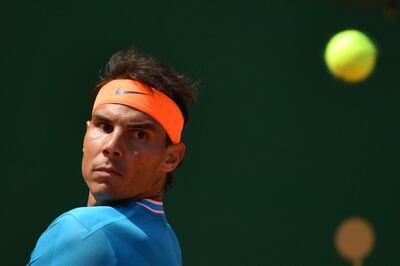 TOPSHOT - Spain's Rafael Nadal eyes the ball against Bulgaria's Grigor Dimitrov during their tennis match on the day 6 of the Monte-Carlo ATP Masters Series tournament in Monaco on April 18, 2019. / AFP / YANN COATSALIOU
